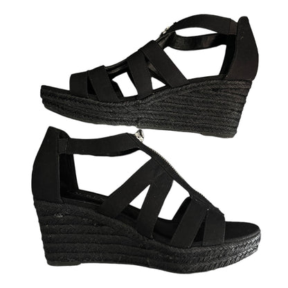 Black wedge sandals with espadrille sole on a white background