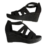 Black wedge sandals with espadrille sole on a white background