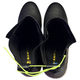 Top of Black shoes with bright green laces on a white background