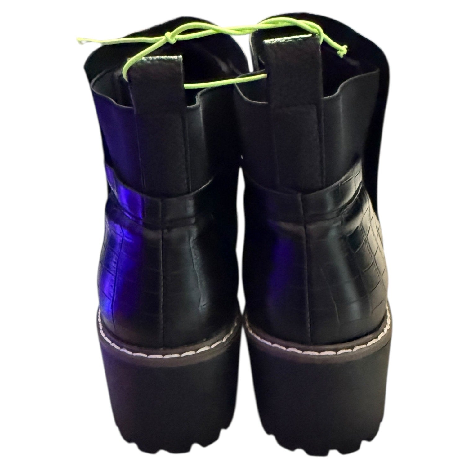 Back of Black platform boots with blue soles on a white background