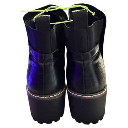 Back of Black platform boots with blue soles on a white background