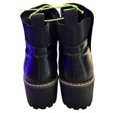 Back of Black platform boots with blue soles on a white background
