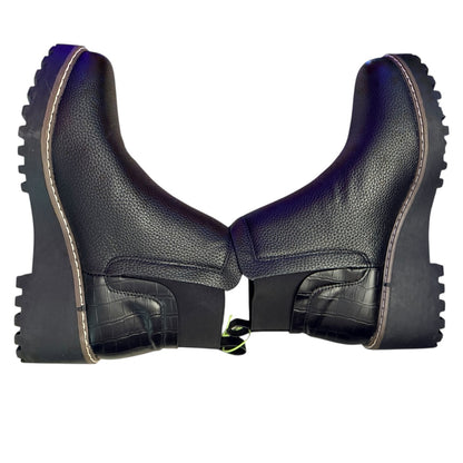 Pair of black faux leather boots on their side on a white background