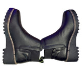 Pair of black faux leather boots on their side on a white background