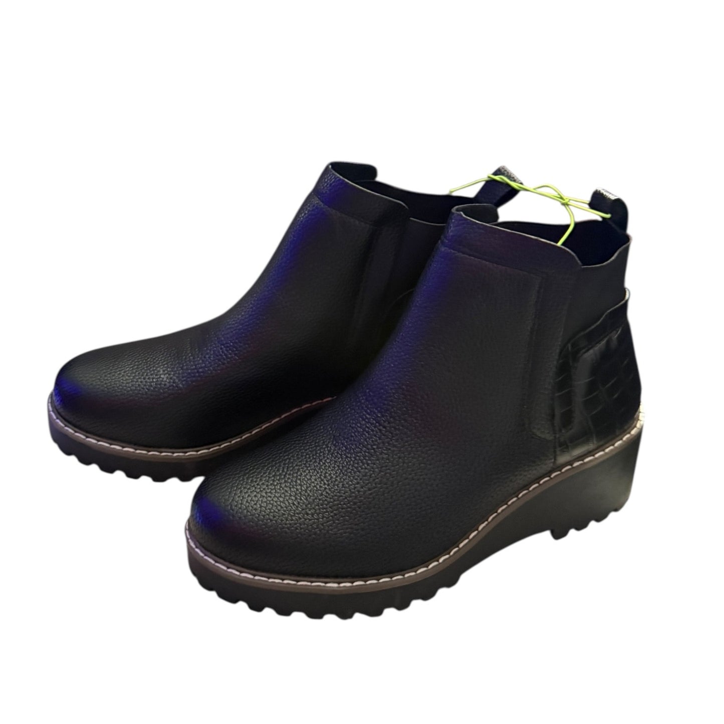 Black faux leather ankle boots on a white background