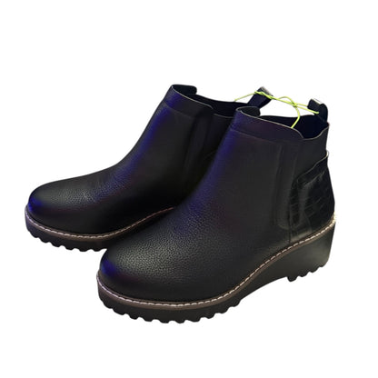 Black faux leather ankle boots on a white background
