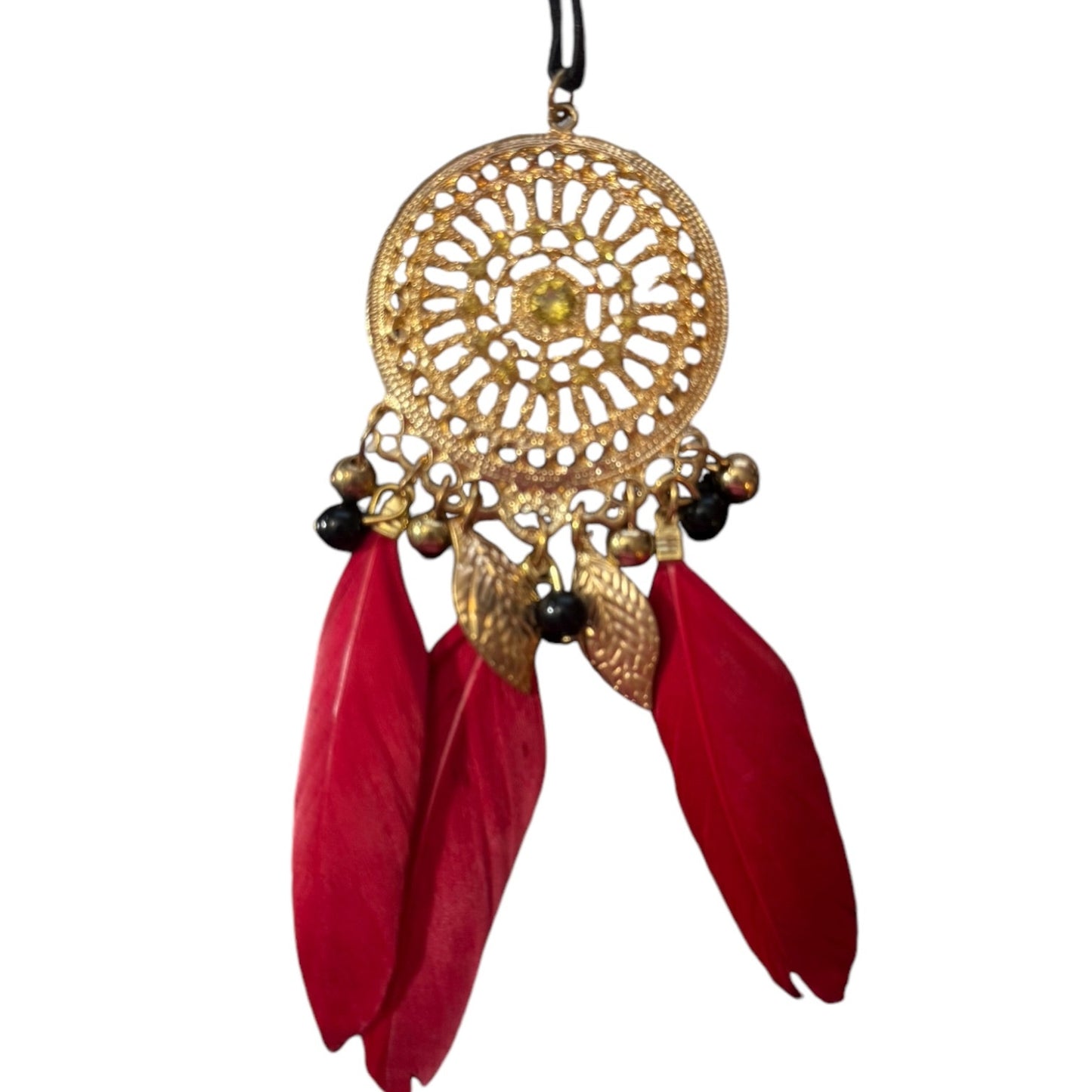 Decorative hanging pendant with gold circular design and red feathers on a white background