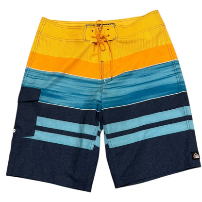 Multicolored striped board shorts with a tie string on a white background