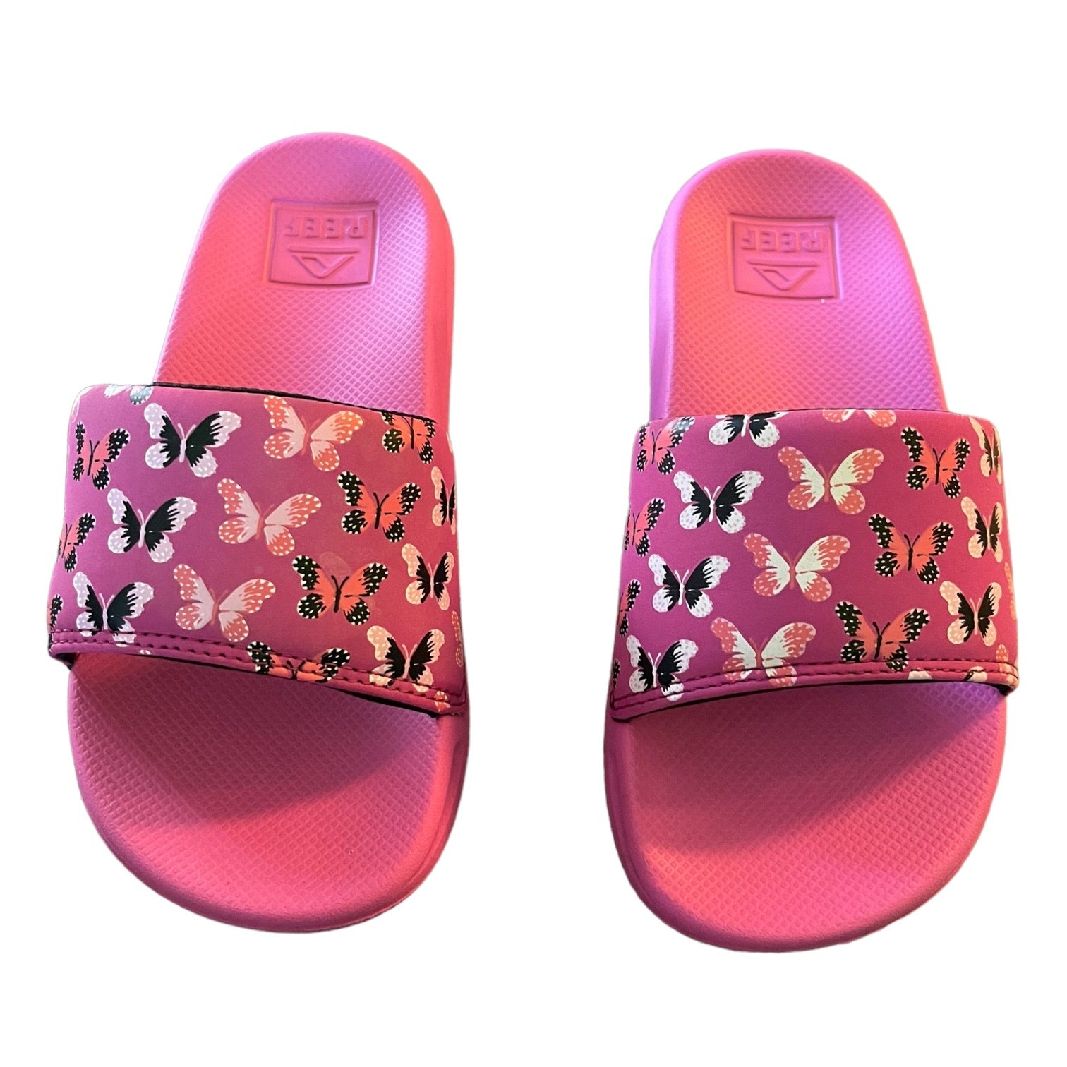 Front of Pink slides with butterfly pattern on a white background