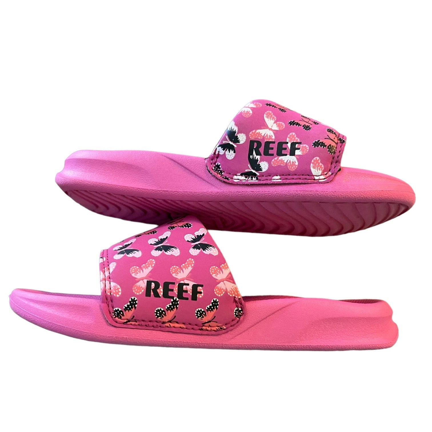 Side of Pink Reef sandals with floral pattern on a white background