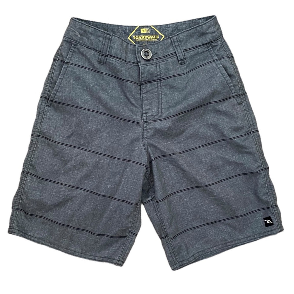 A pair of gray shorts with thin black horizontal stripes, featuring a button closure, belt loops, and a visible logo patch on the lower left leg.