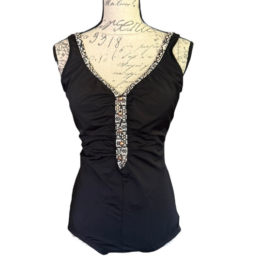 Black swimsuit front with decorative neckline on a mannequin against a white background