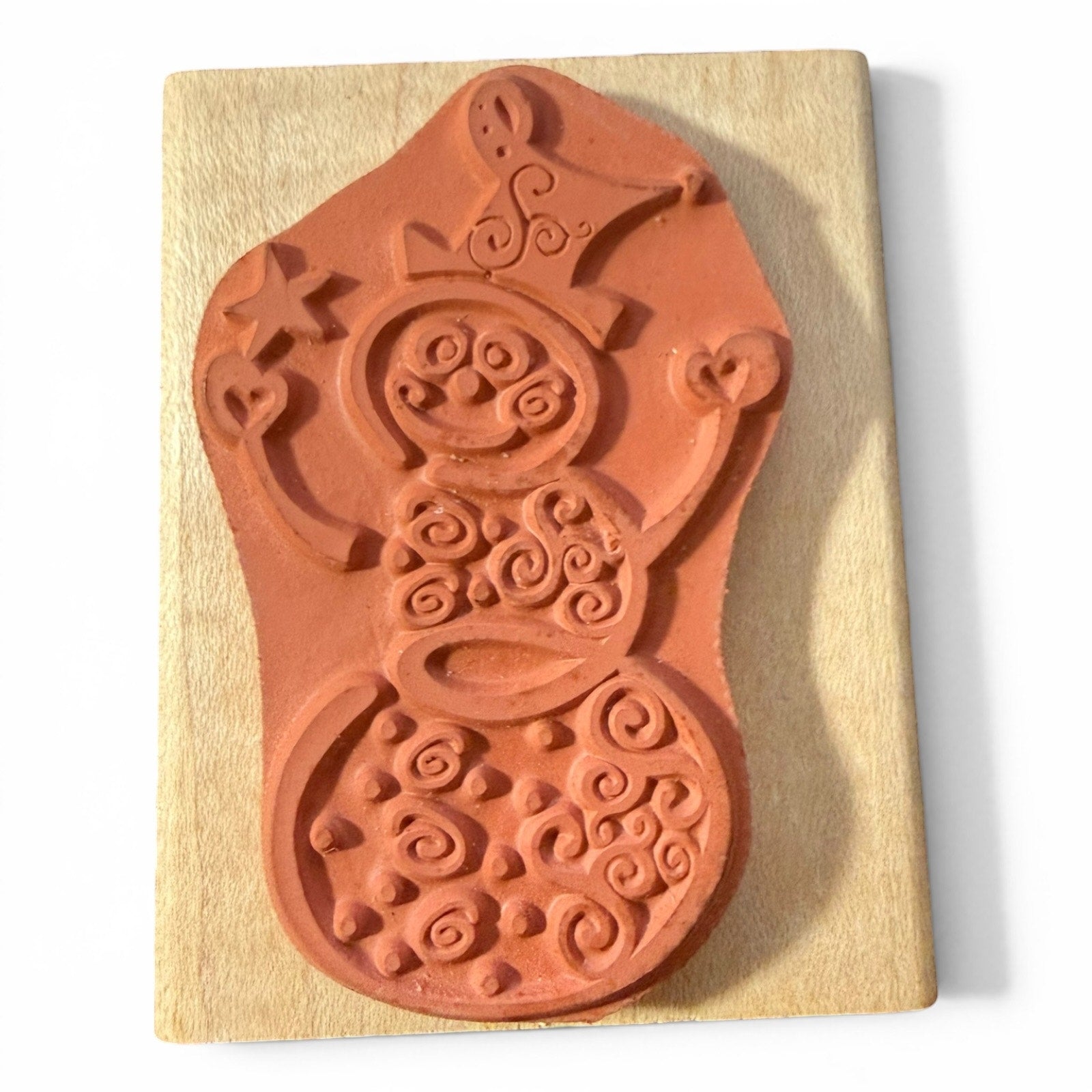 Rubber stamp of a snowman on a wooden block