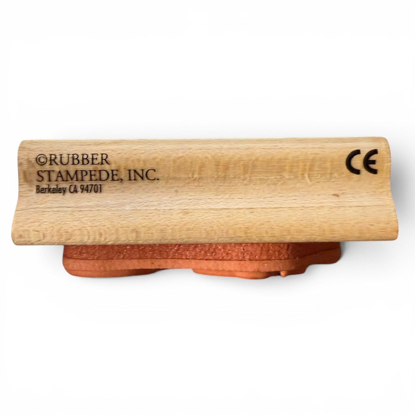 Wooden stamp with 'Rubber Stampede, Inc.' branding on a white background