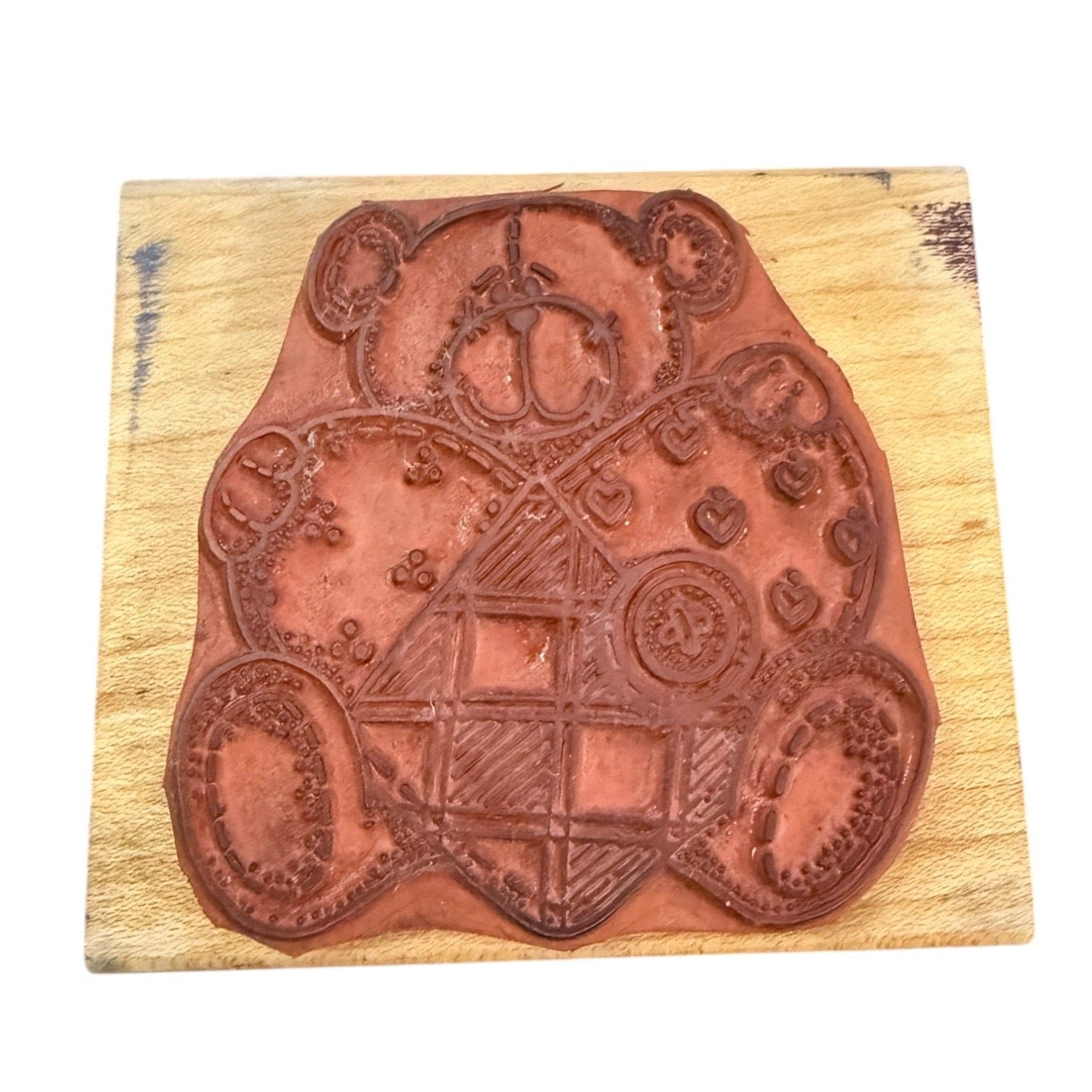 Decorative wooden stamp with intricate designs on a wooden block
