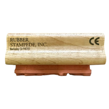 A wooden rubber stamp block with a terracotta-colored rubber foot, branded 'RUBBER STAMPEDE, INC.' with a CE mark, shown on a plain white background.