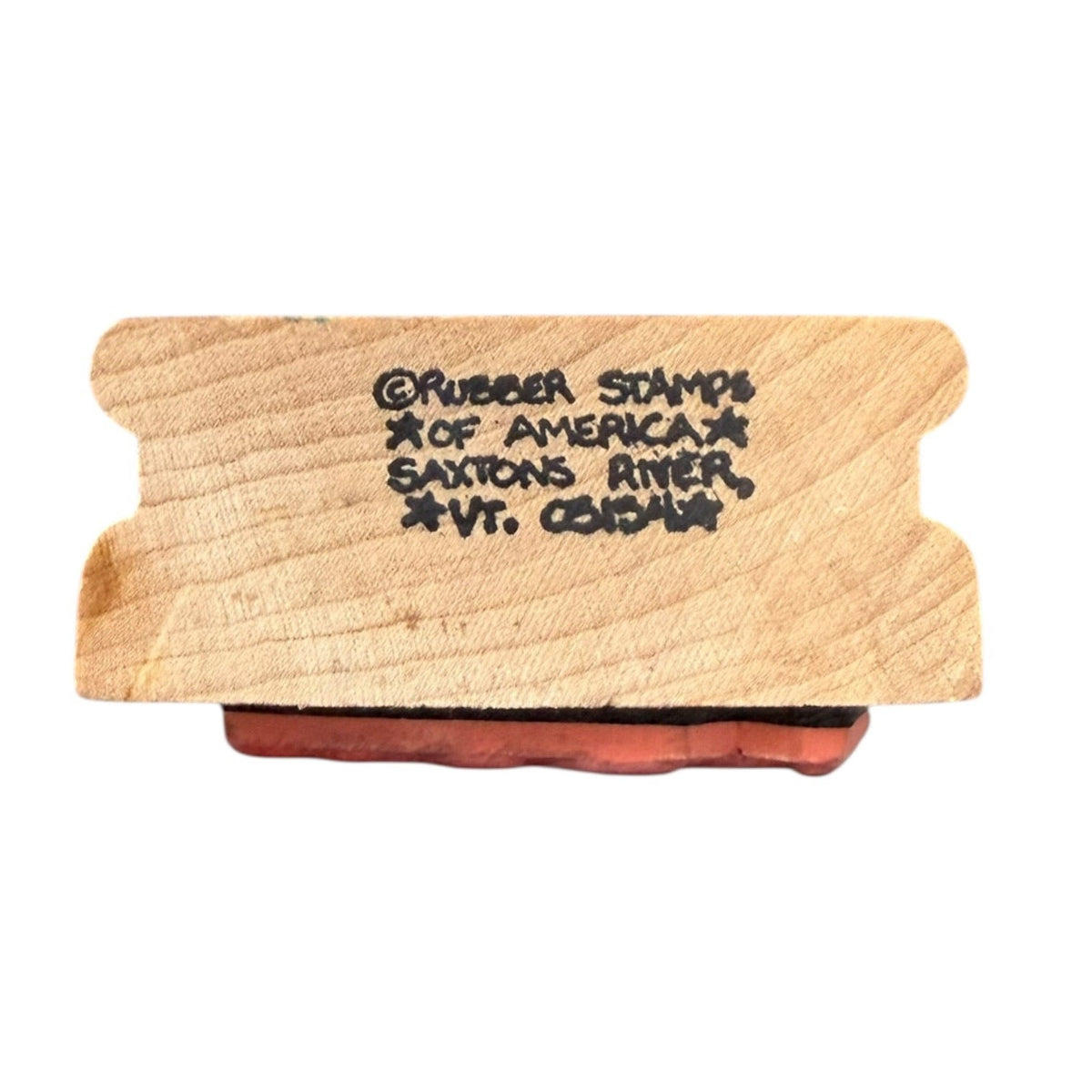 A wooden rubber stamp block with engraved black text reading '@Rubber Stamps of America Saxons River, Avt. G.