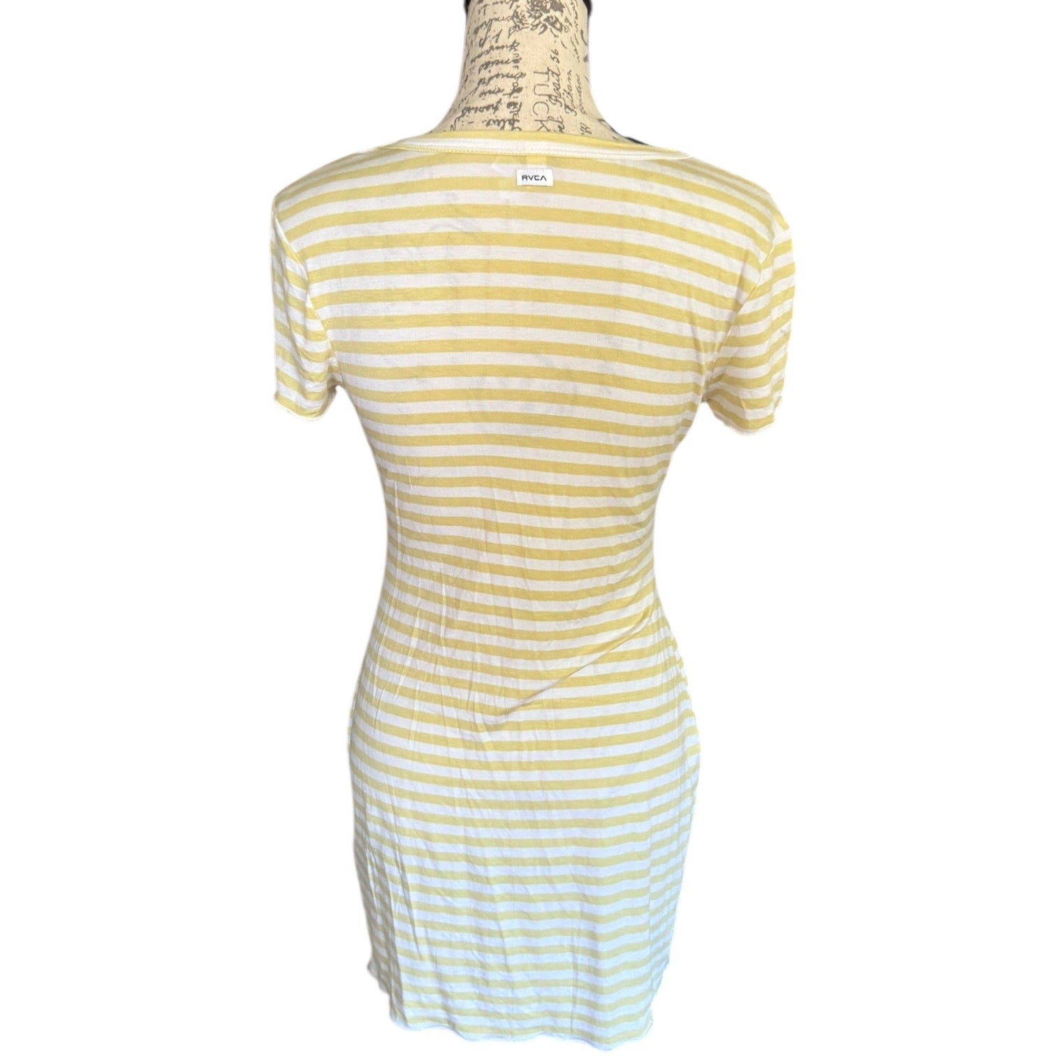 Back of green and white striped dress on a mannequin against a white background