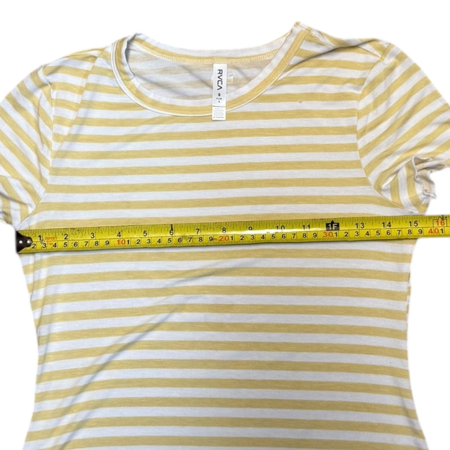 Green and white striped t-shirt with a measuring tape on a white background