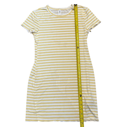 Green and white striped dress with a measuring tape on a white background