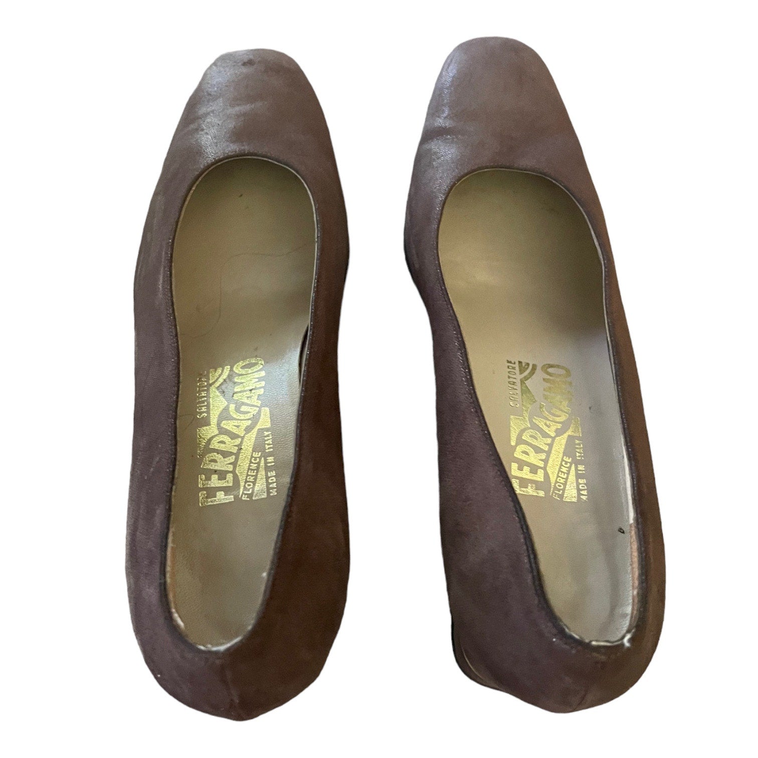 A pair of Ferragamo pointed-toe heels in dark brown suede, shown from a top-down view on a white background.