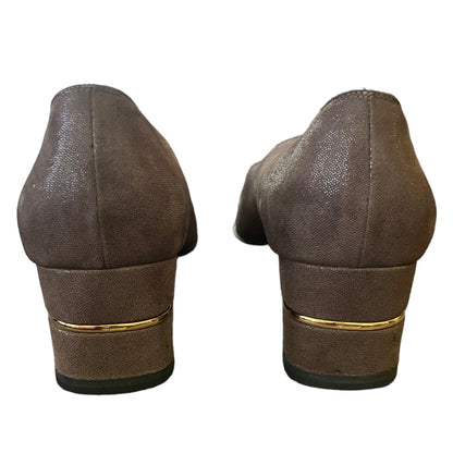 A pair of women's brown suede pumps shown from the back, featuring a stacked block heel with a thin gold metallic accent band.