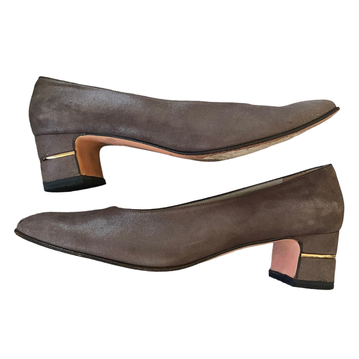 A pair of women's pumps in dark brown suede, featuring a low block heel with a gold accent band and a light tan insole, shown against a plain white background.