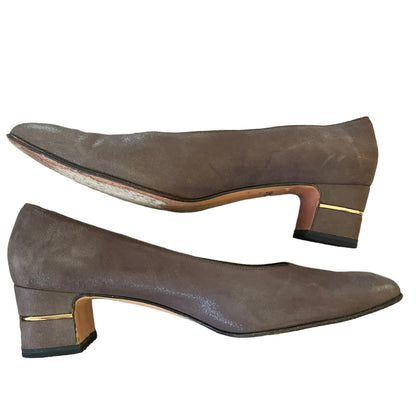 A pair of women's pumps in brown suede, featuring a block heel with a gold accent band and a black outsole, shown against a plain white background.