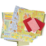 Collection of colorful paper sheets with various designs on a white background