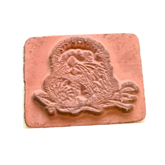Rubber stamp with a sea otter design on a white background