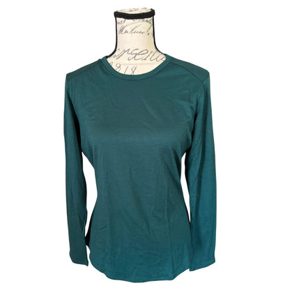 A dark  green long-sleeve shirt displayed on a vintage-style mannequin torso against a plain white background.