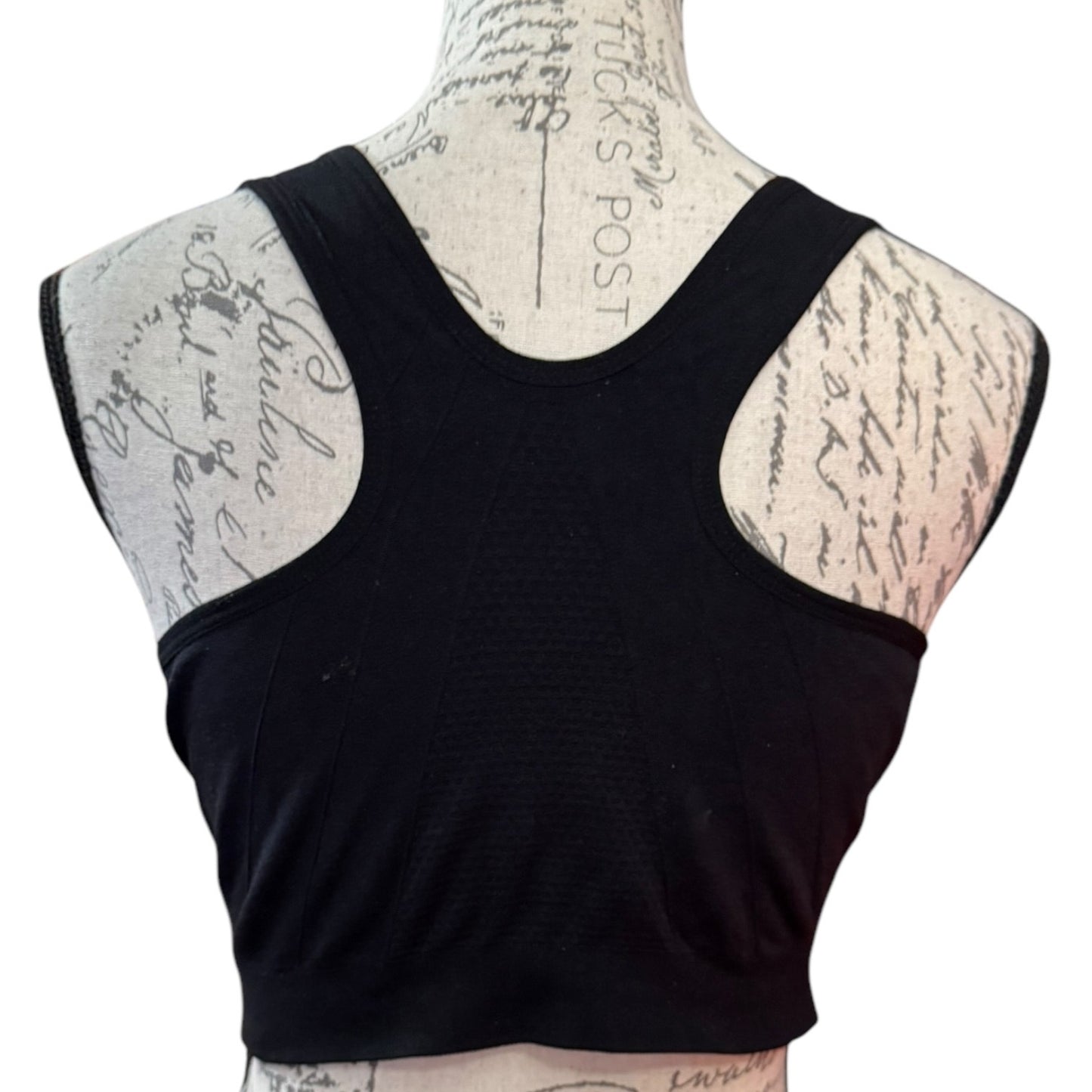 Black back of sports bra on a mannequin with a white background