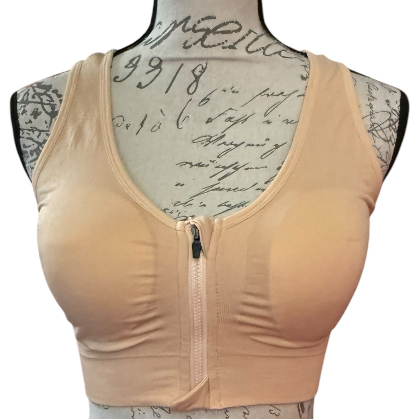 Beige front of sports bra on a mannequin with a white background