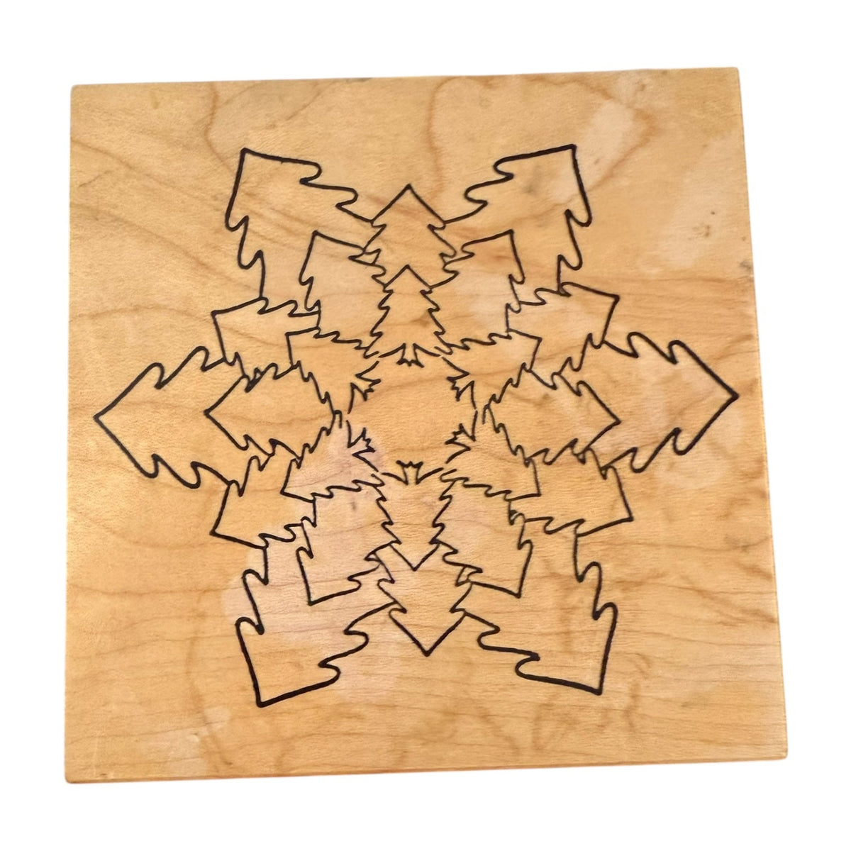 A square wooden stamp with trees shaped as a snowflake, shown on a plain white background.
