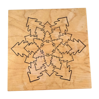 A square wooden stamp with trees shaped as a snowflake, shown on a plain white background.