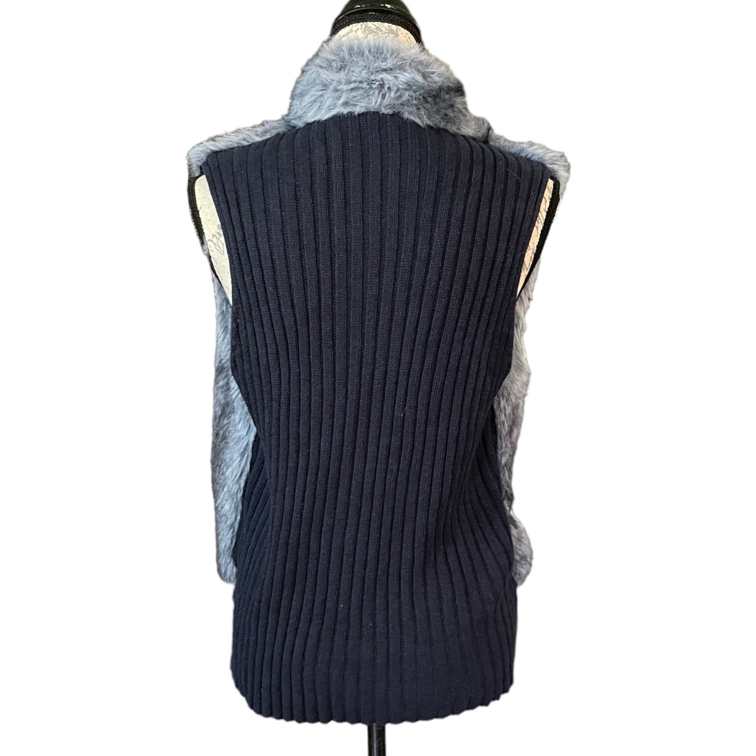 Back of Dark blue ribbed knit vest with fur trim on a mannequin against a white background