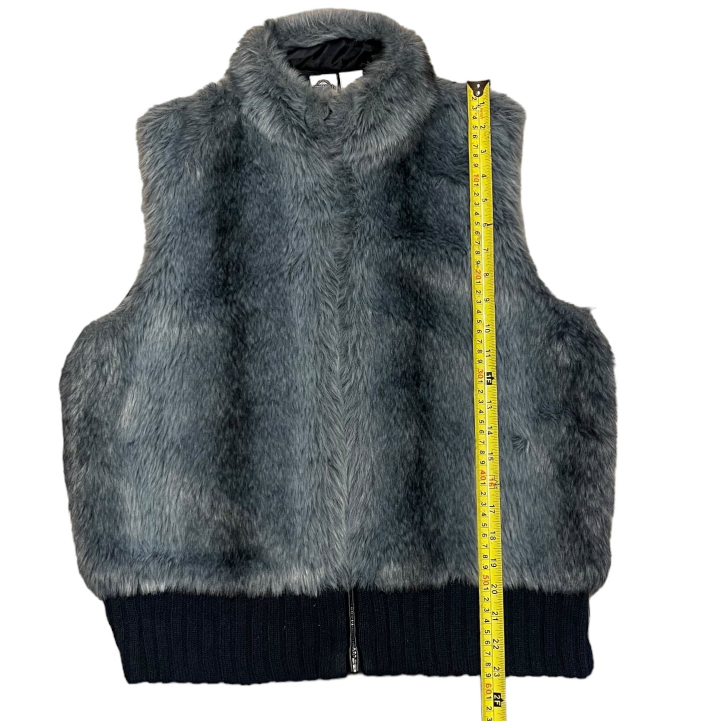 Blue-Gray fur vest with a measuring tape for size reference on a white background