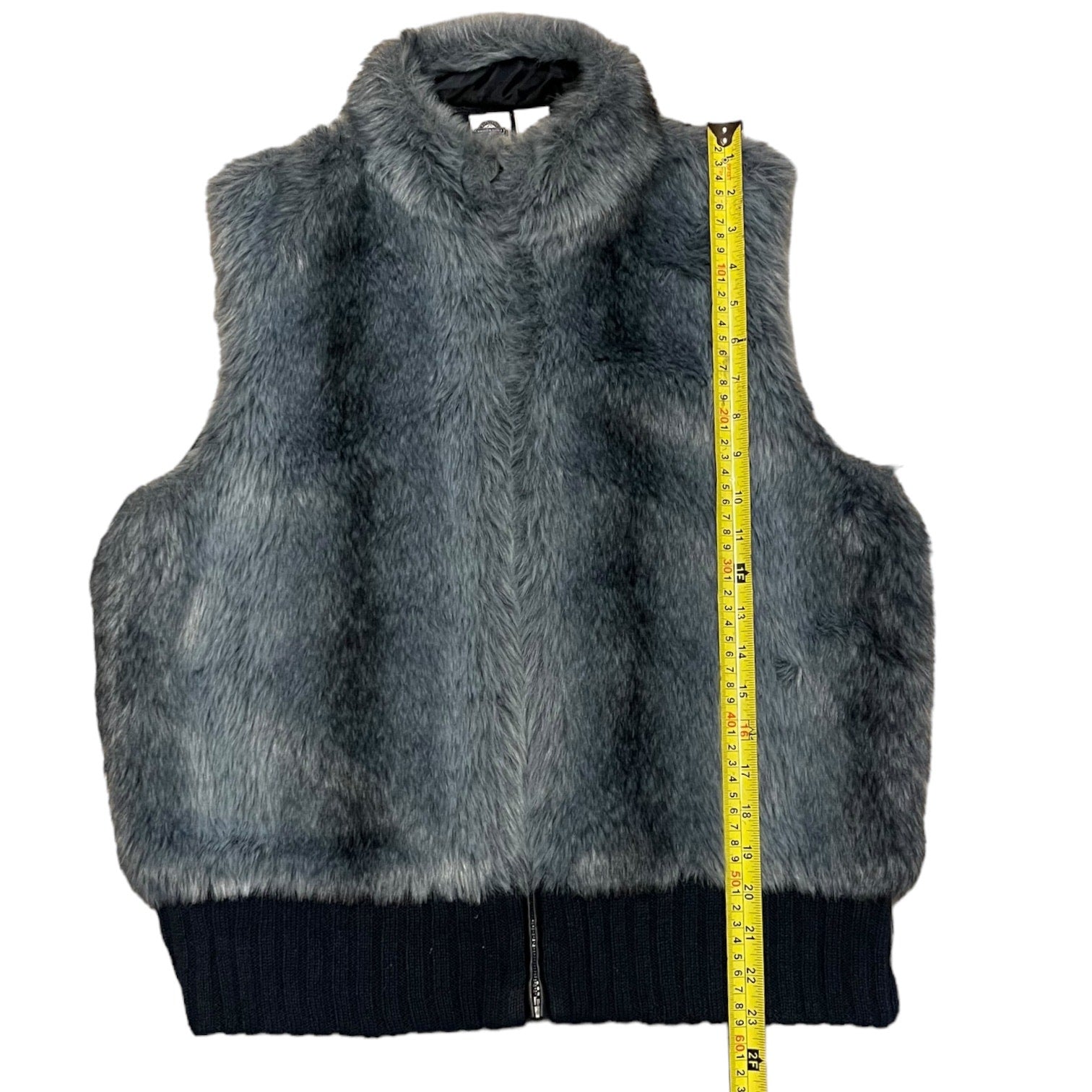 Blue-Gray fur vest with a measuring tape for size reference on a white background