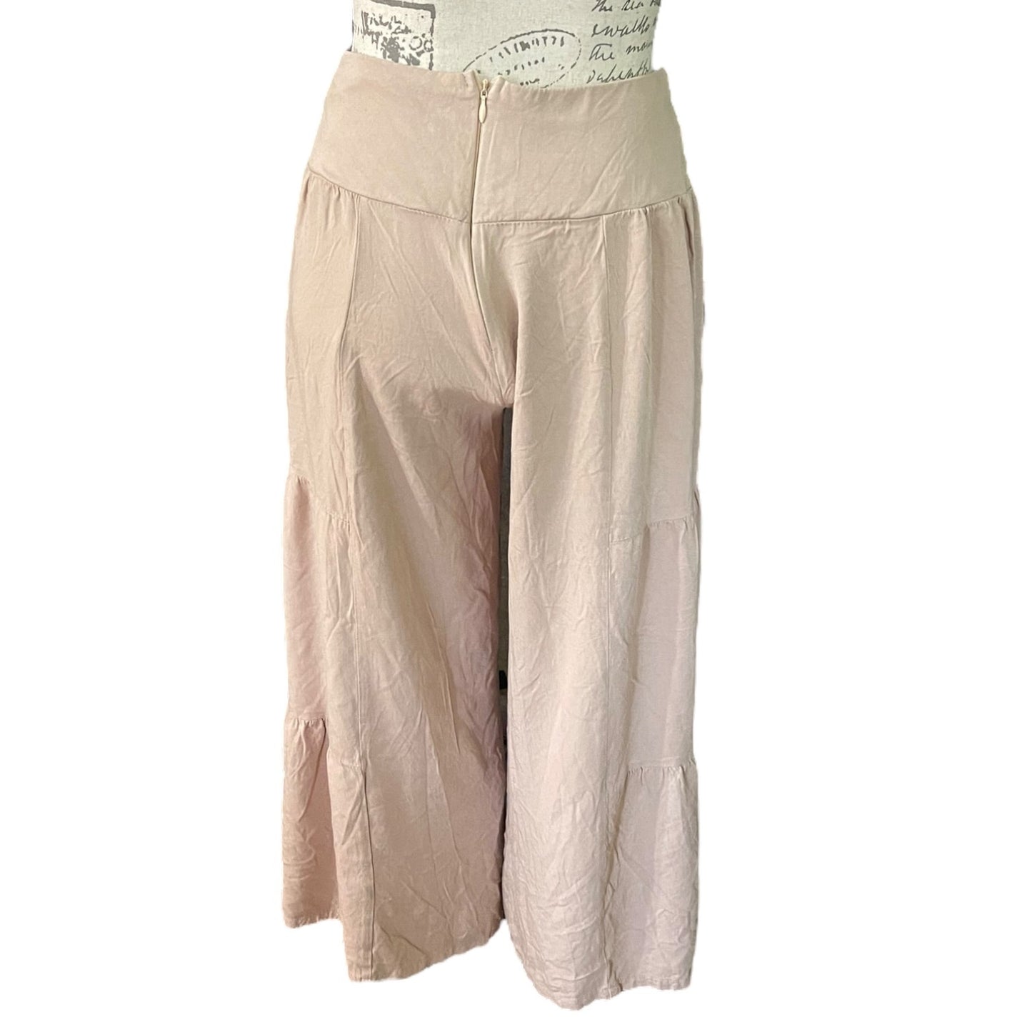 A pair of loose, high-waisted cropped pants , displayed on a dress form against a plain white background.