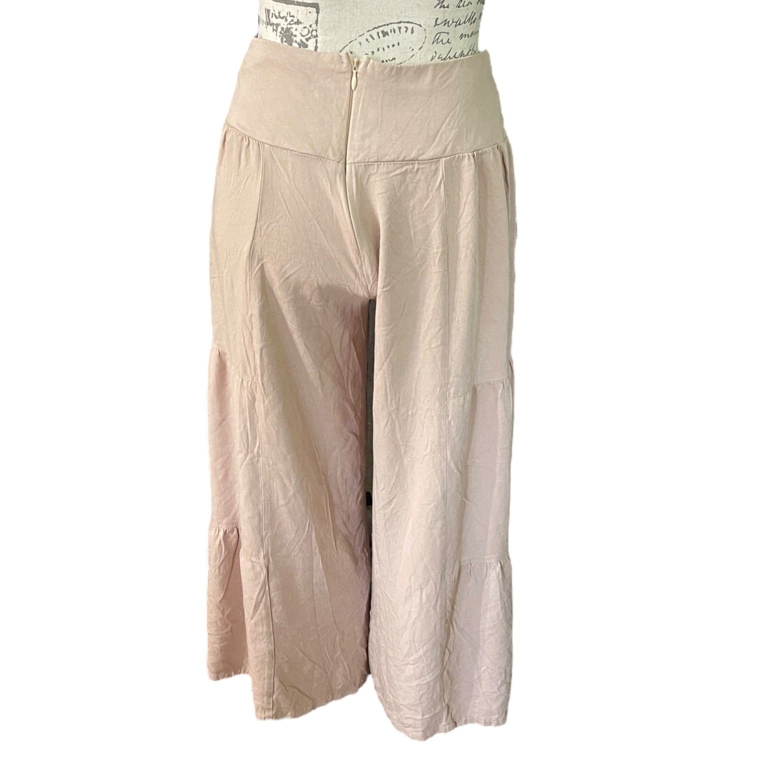 A pair of loose, high-waisted cropped pants , displayed on a dress form against a plain white background.