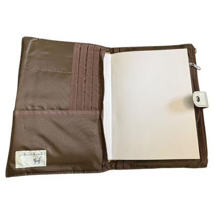 Interior of journal cover with open notebook on a white background