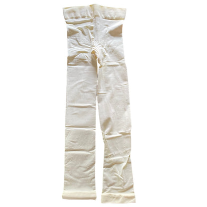 A pair of ivory colored tights laid flat against a solid white background.