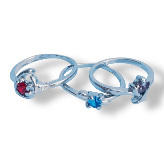 Set of 3 rings with gemstones on a white background