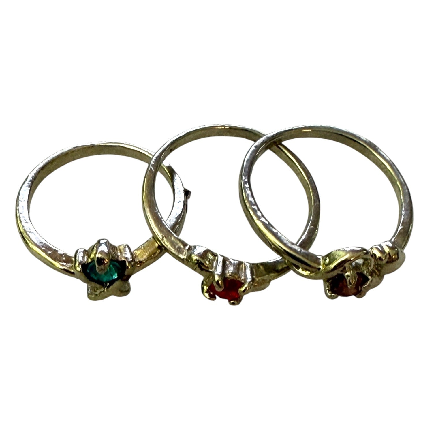 Top view of 3 stackable silver rings with gemstones on a white background