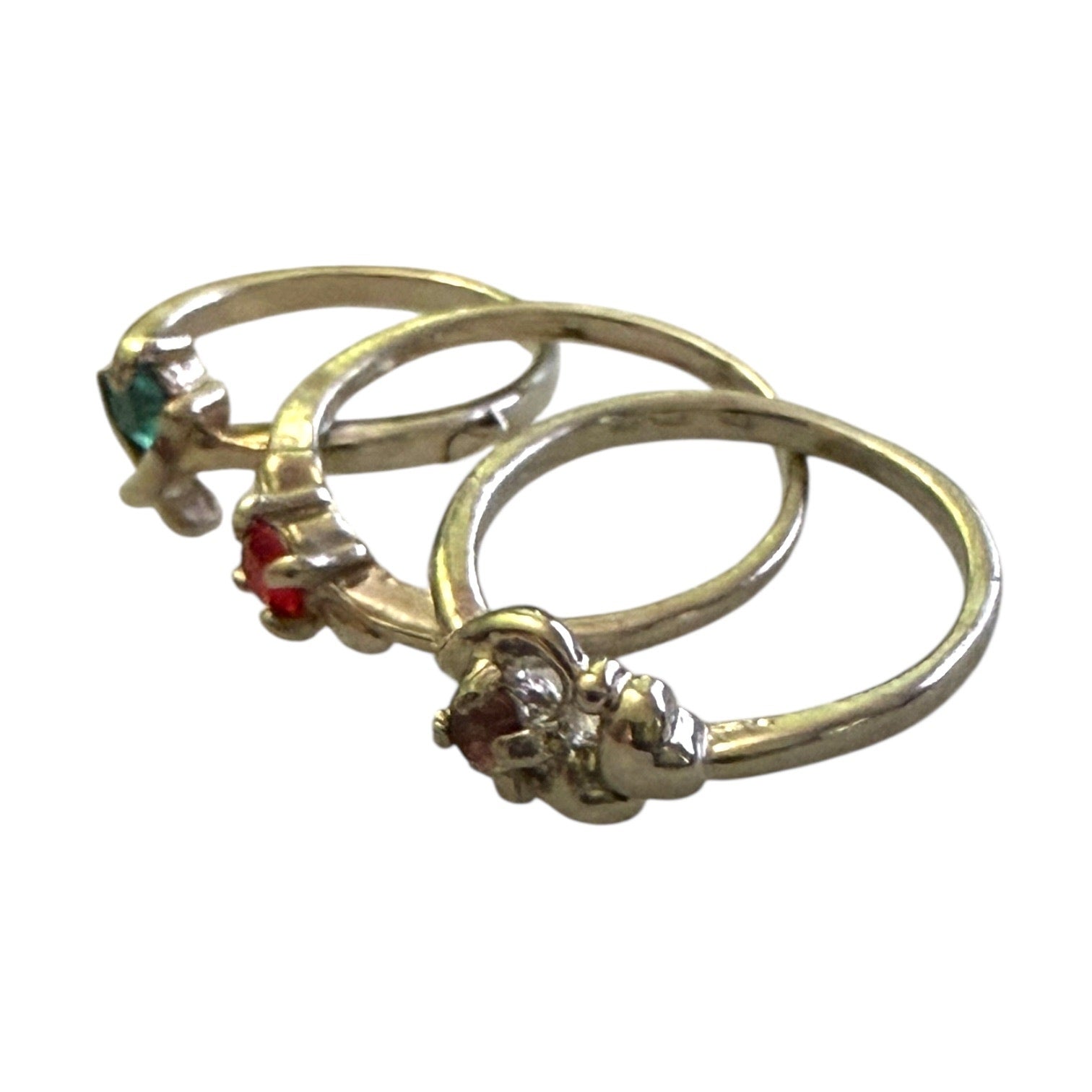 Side view of 3 silver stackable rings with gemstones on a white background