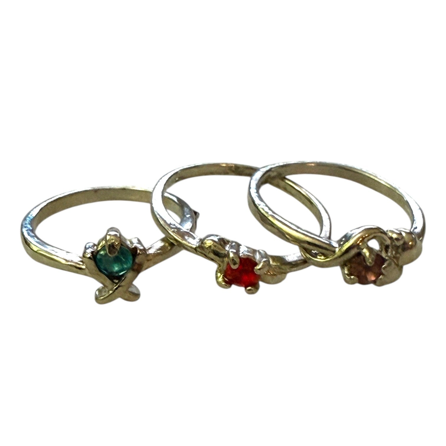 Three silver rings with gemstones on a white background