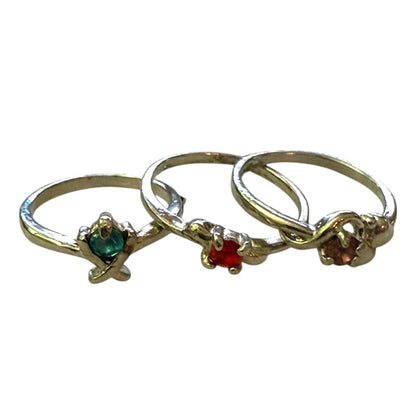 Three silver rings with gemstones on a white background