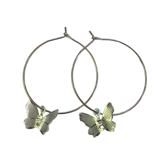 A pair of silver-tone hoop earrings with textured butterfly charms, displayed against a solid white background.
