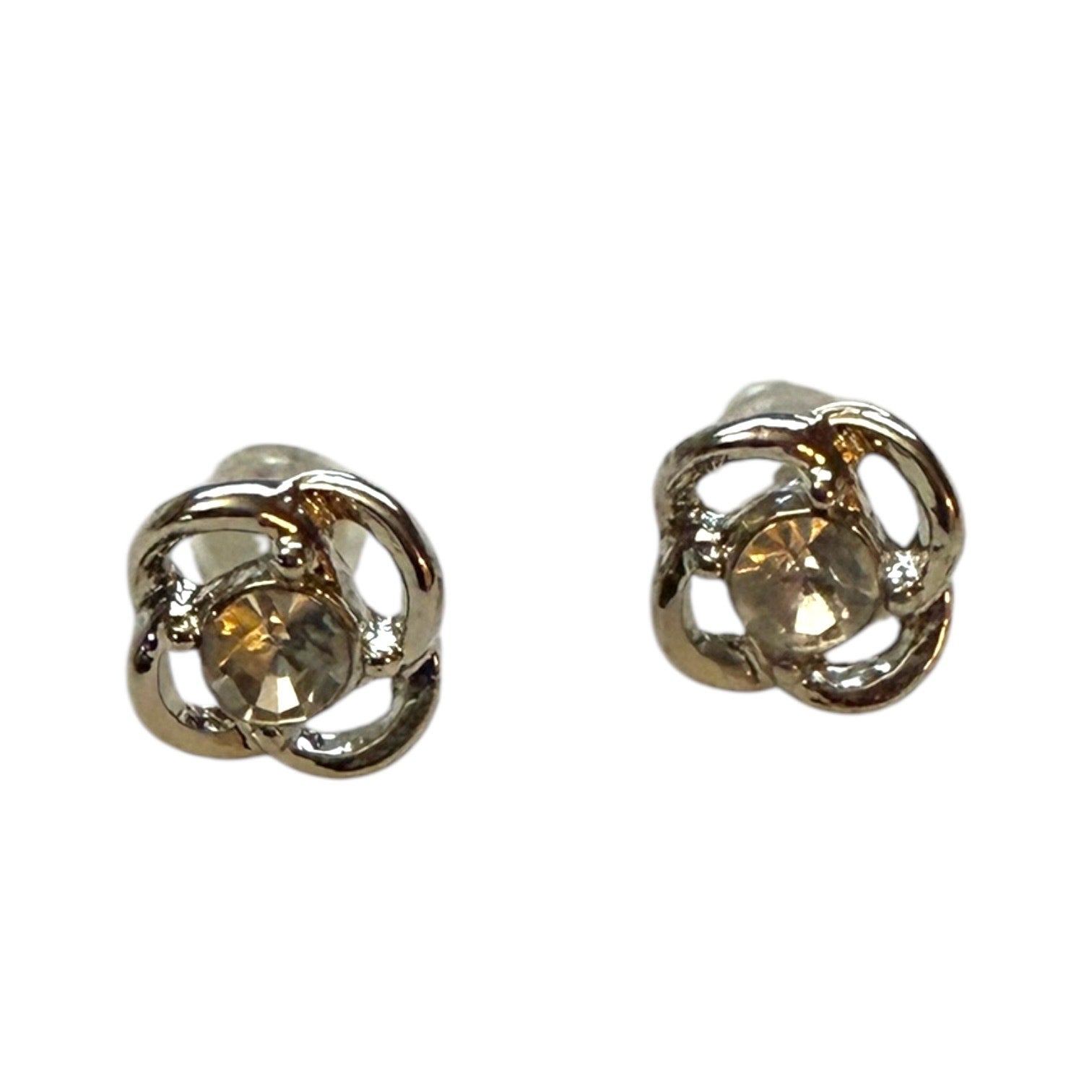 A pair of silver-toned stud earrings with a central faceted gemstone in a flower design, shown on a plain white background.