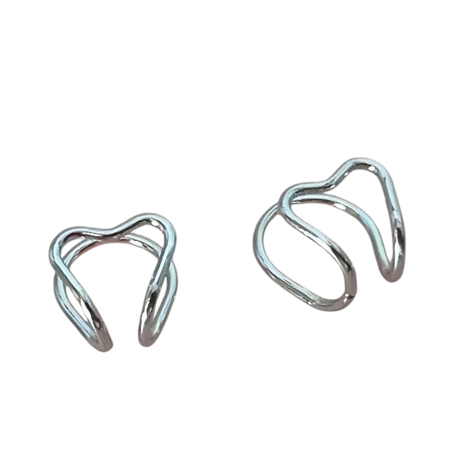 Pair of silver heart cuff earrings on a white background